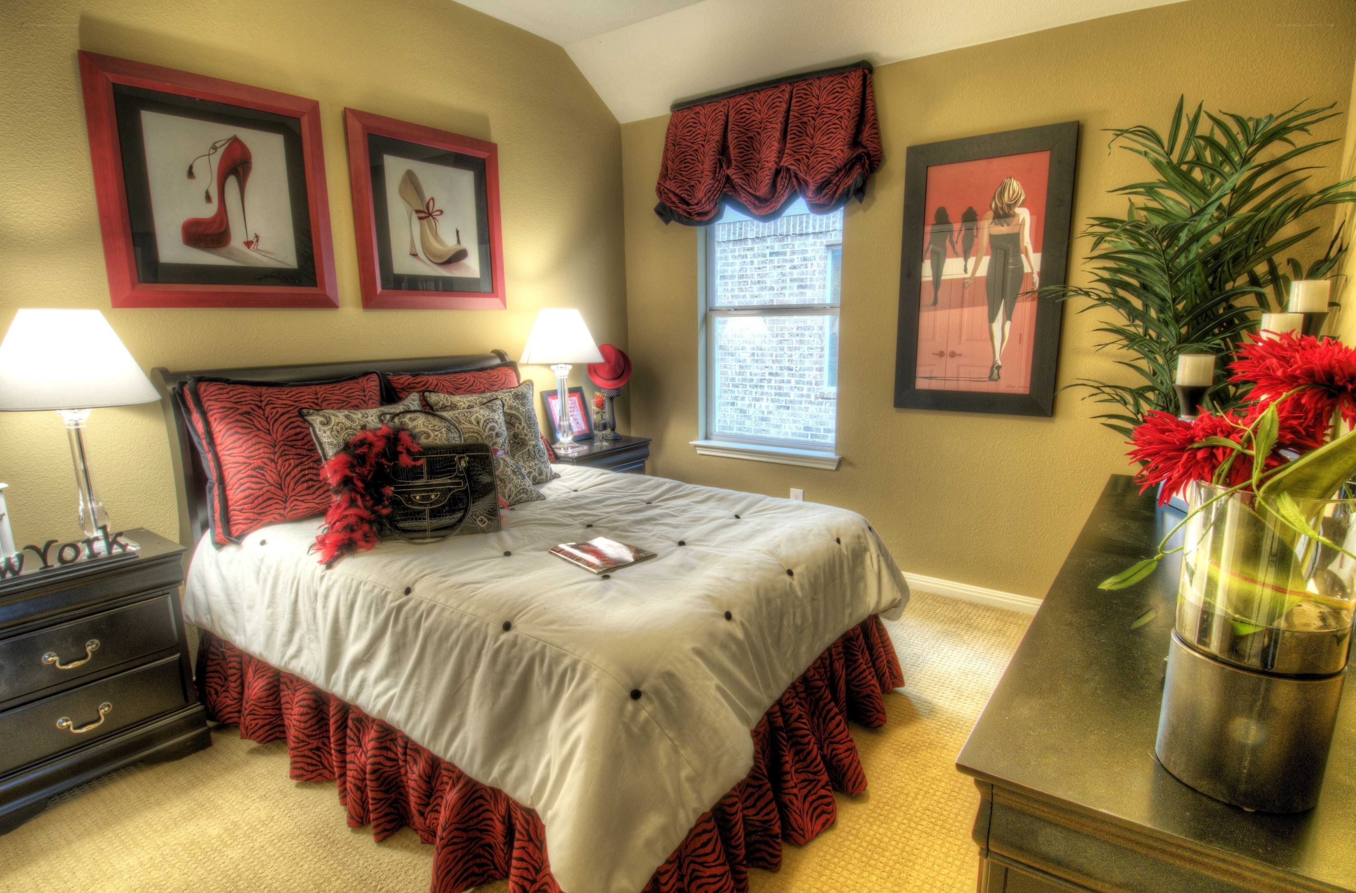 Red and beige bedroom with art