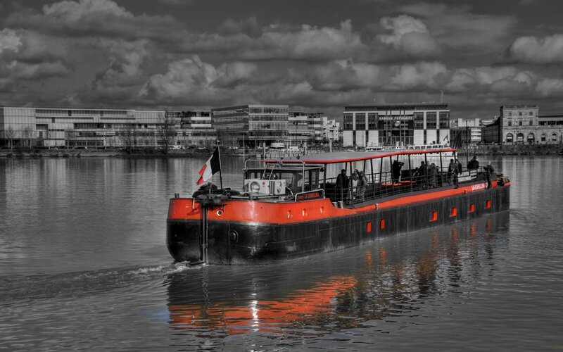 Red and black barge on a river