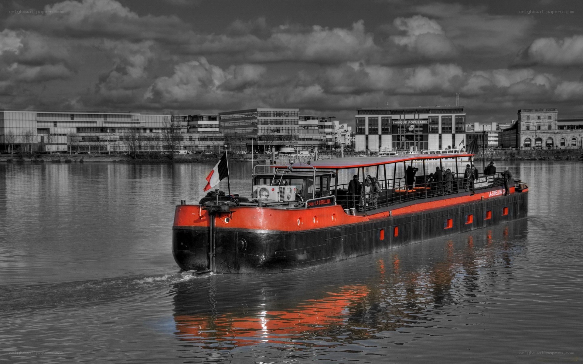 Red and black barge on a river