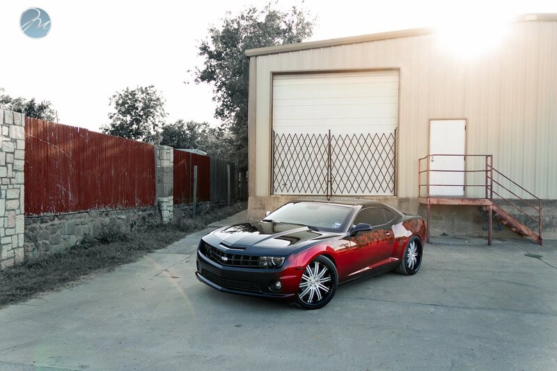 Red and black Camaro in driveway