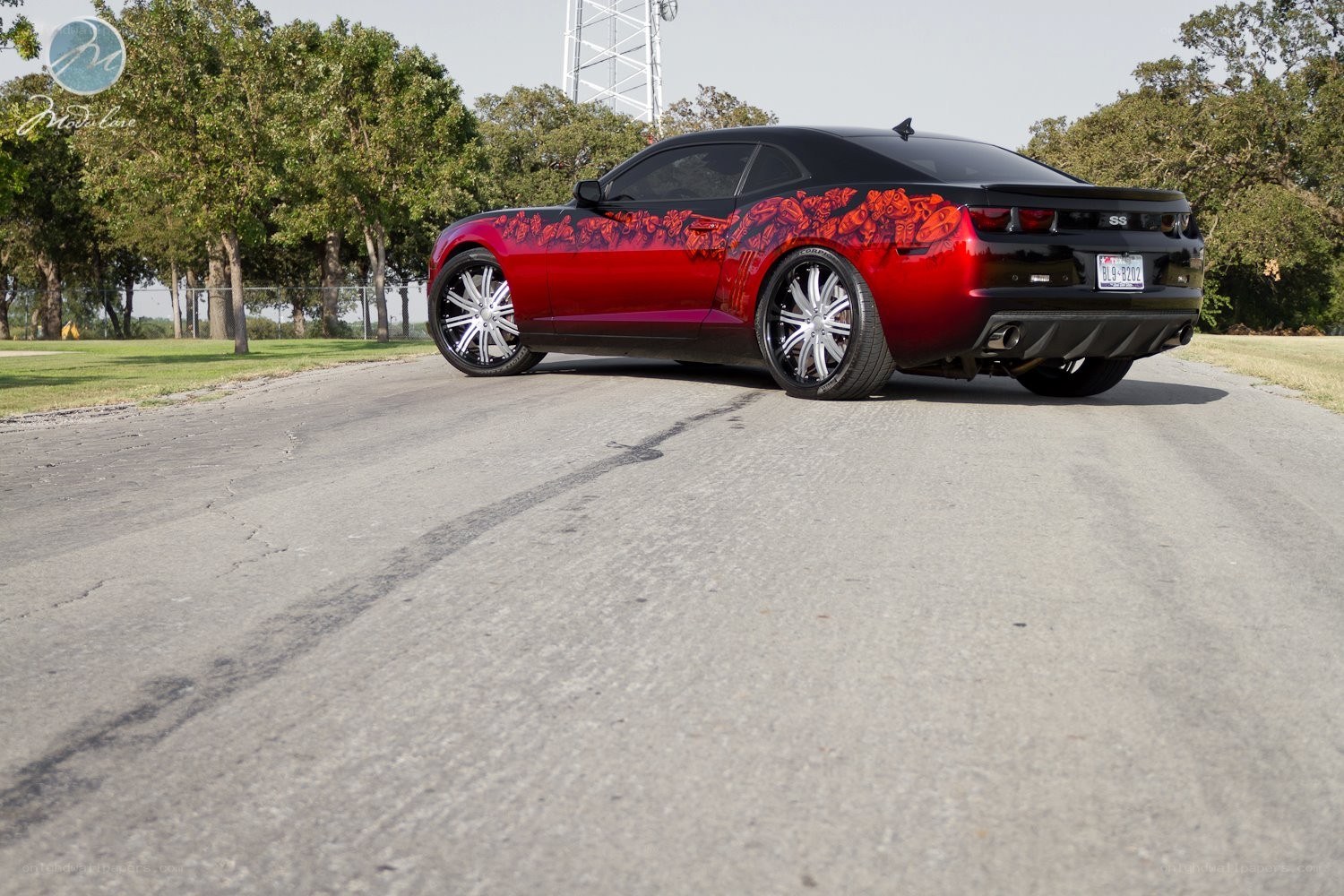 Red and black Camaro with custom graphics