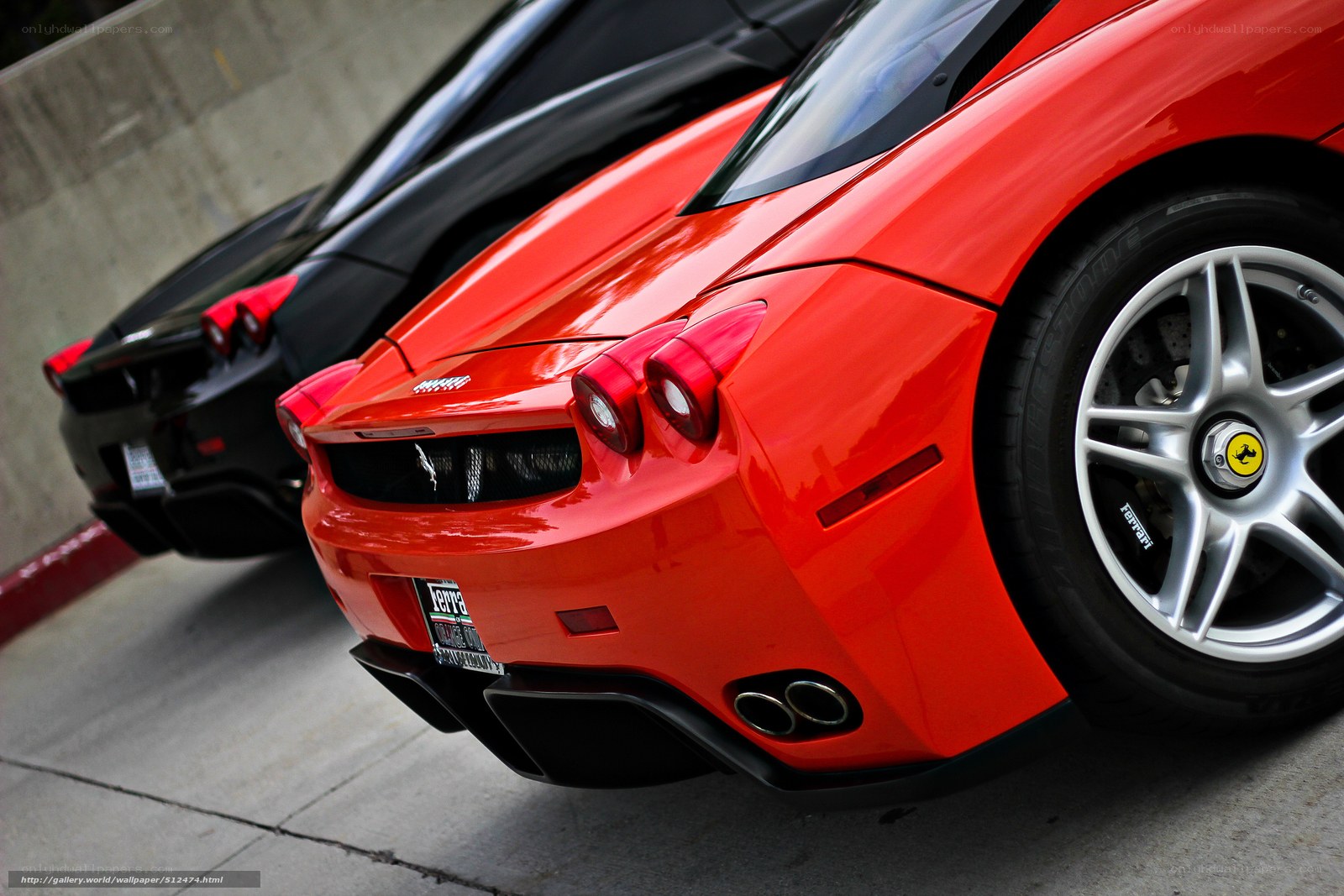 Red and black Ferraris parked