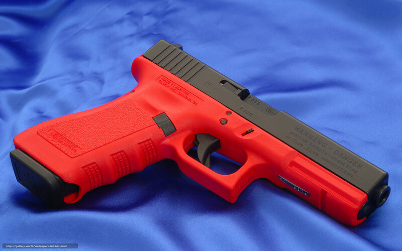 Red and black handgun on blue cloth