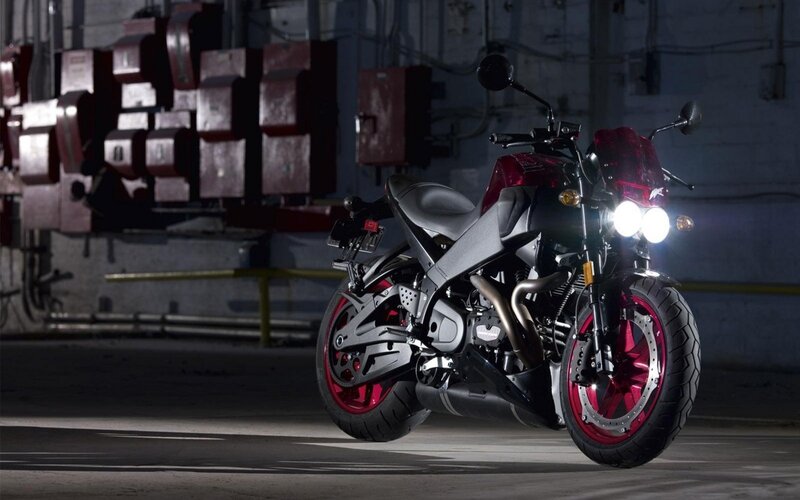 red and black motorcycle in garage