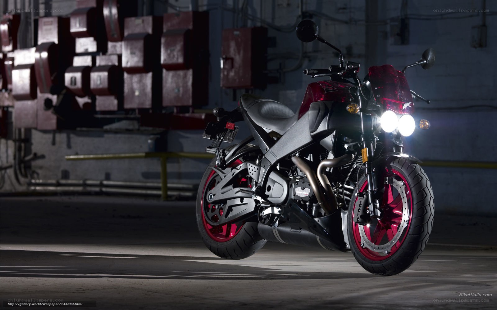 red and black motorcycle in garage