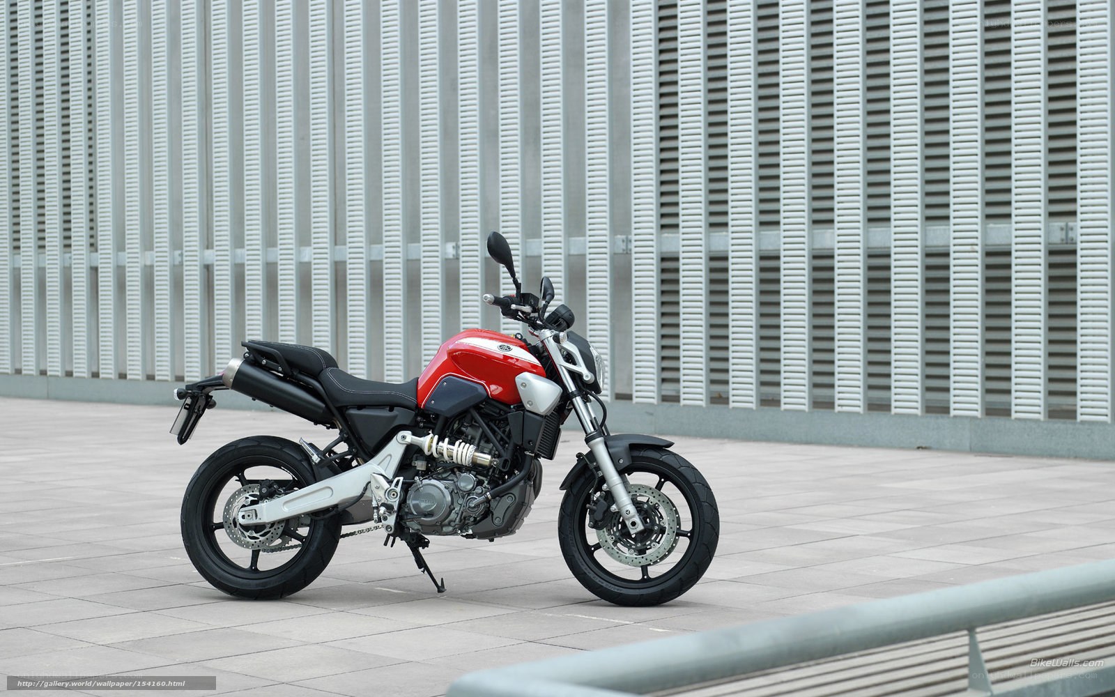 Red and black motorcycle on pavement