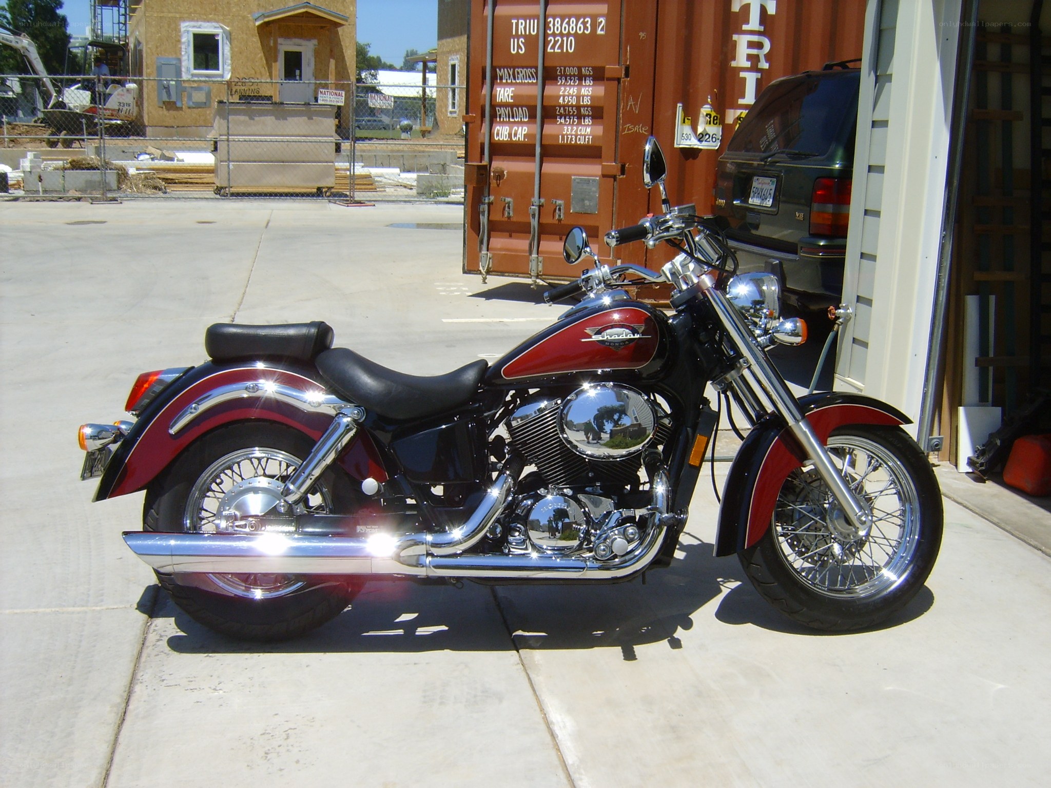 Red and black motorcycle parked outside