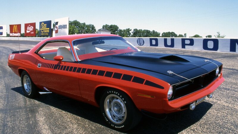 Red and black muscle car on track
