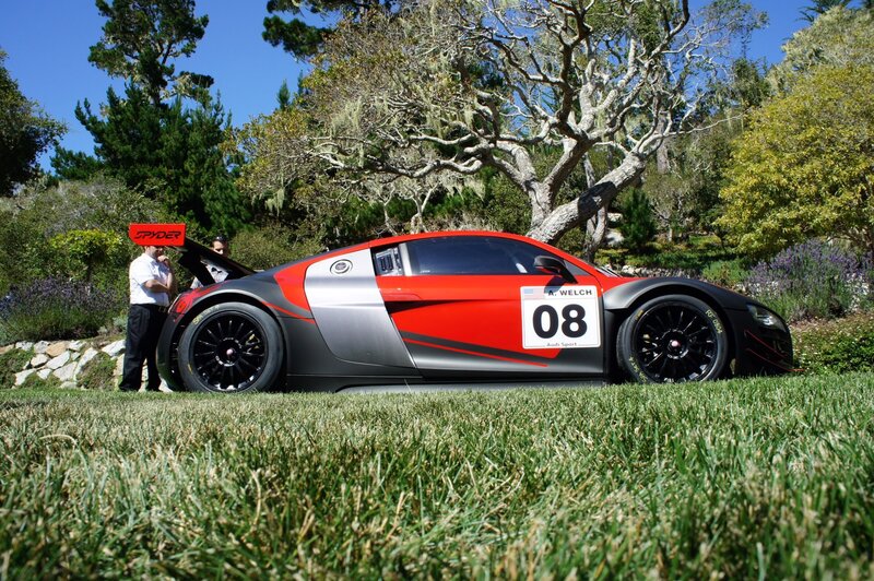 Red and black race car on grass