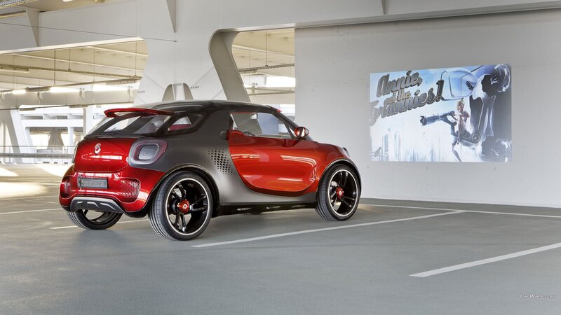Red and black smart car in garage