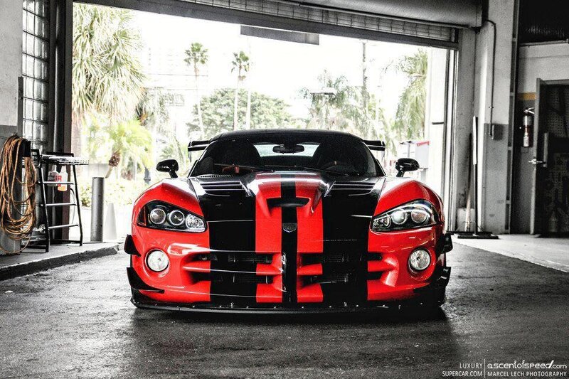 Red and black sports car in garage