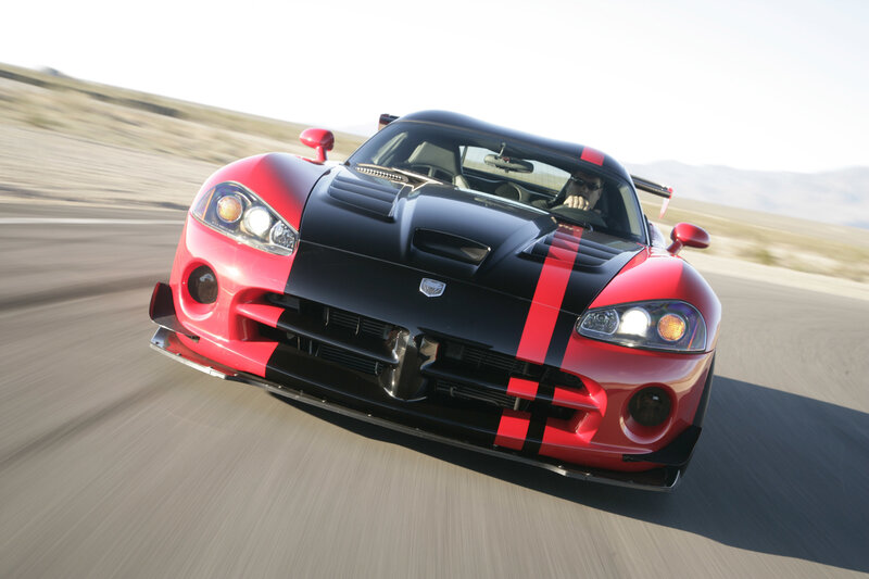 Red and black sports car in motion