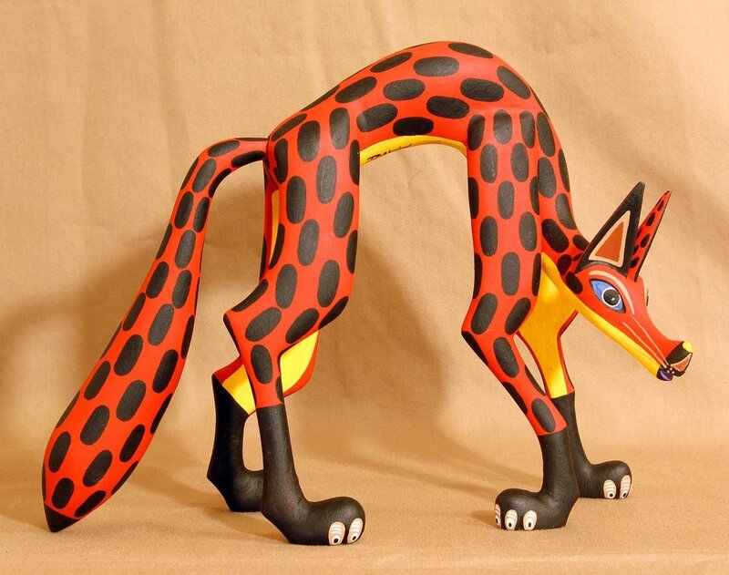 Red and black spotted fox sculpture