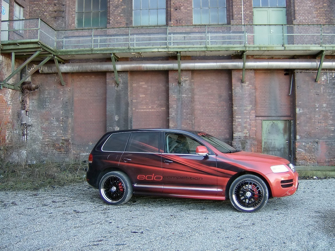 Red and black SUV in industrial setting