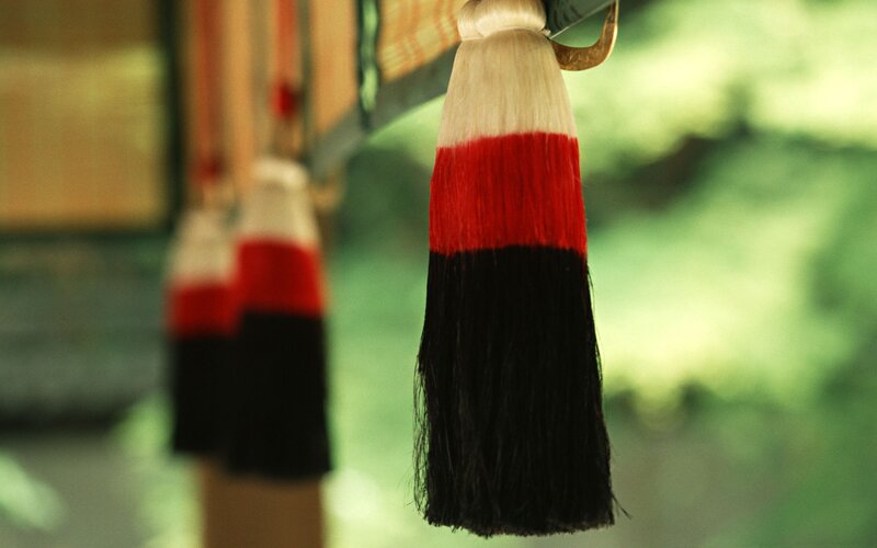 Red and black tassels at a shrine