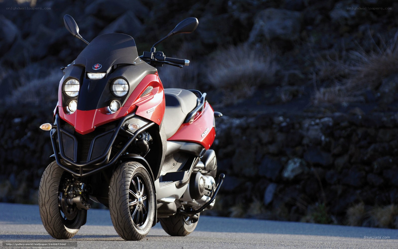 red and black three-wheeled scooter