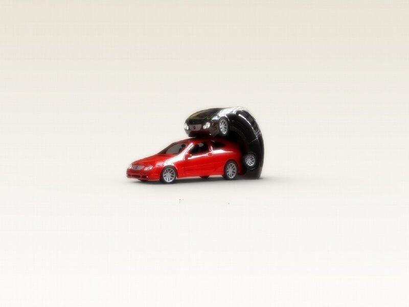 Red and black toy cars stacked