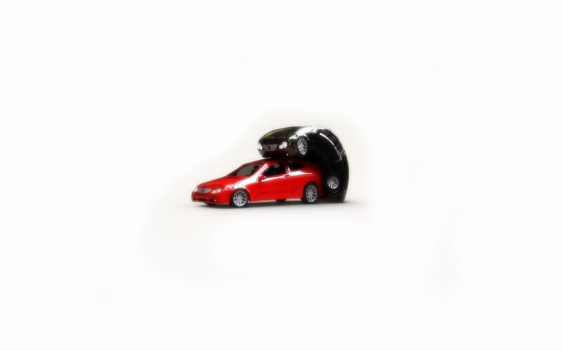 Red and black toy cars stacked