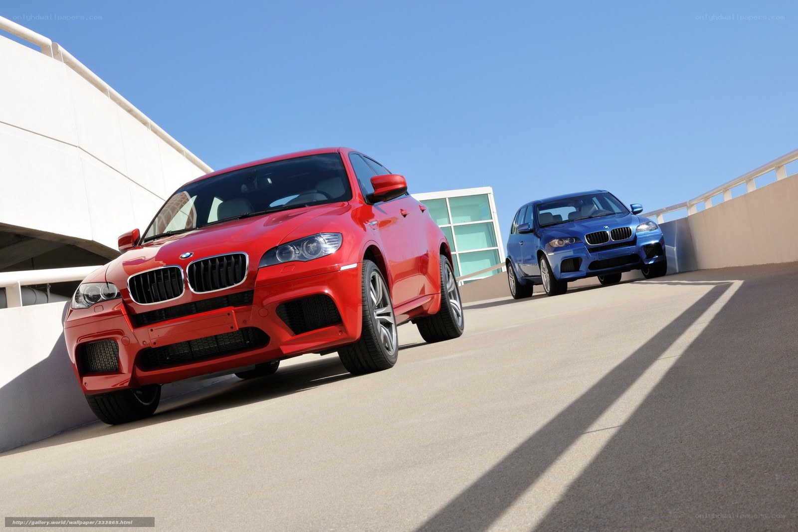 Red and blue BMW SUVs on ramp