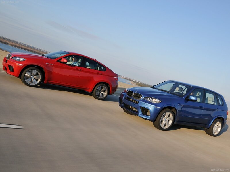 Red and blue BMW SUVs on road