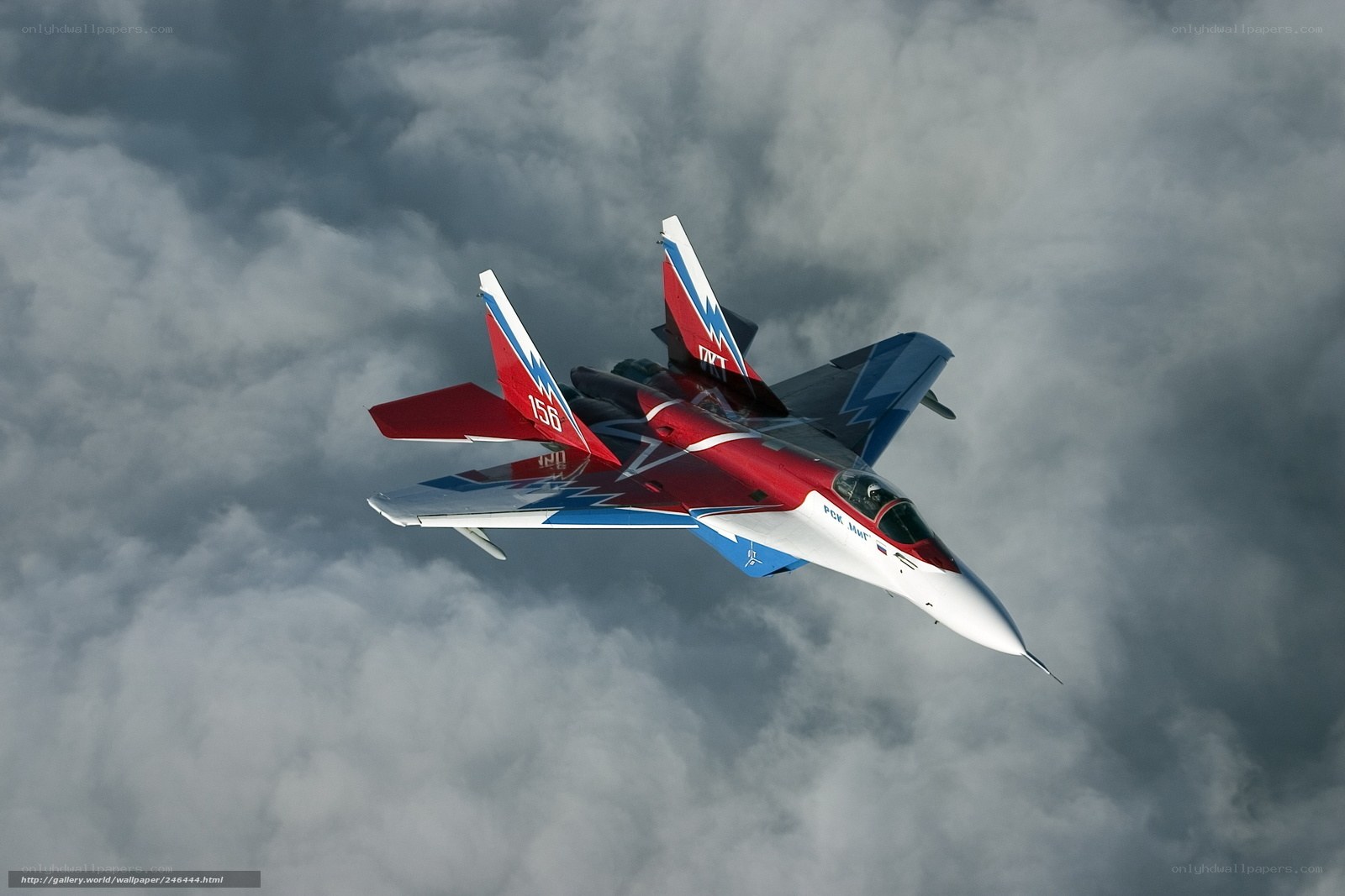 Red and blue fighter jet in clouds