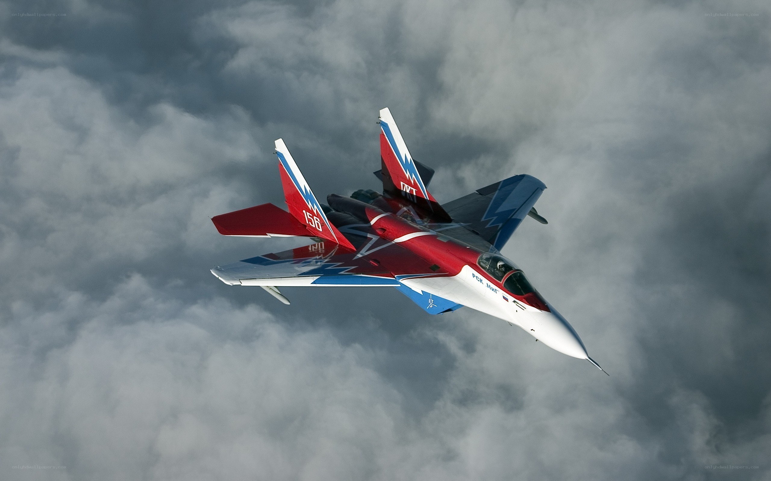 Red and blue fighter jet in flight