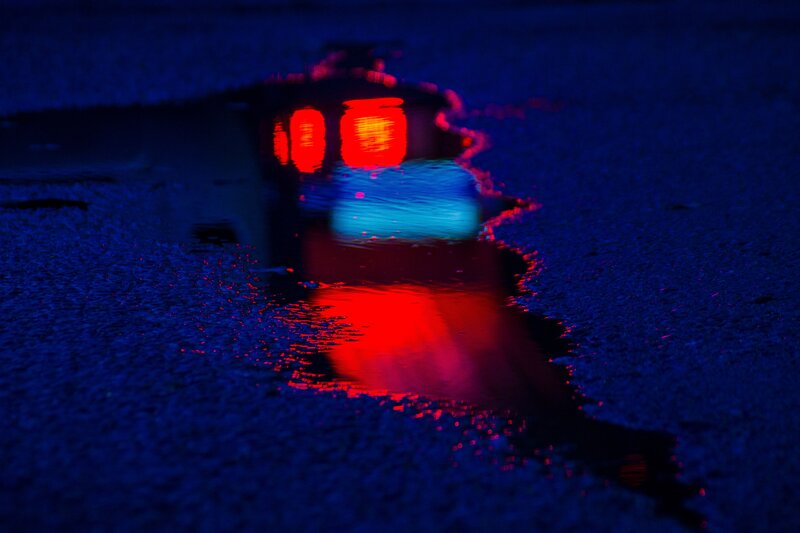 Red and Blue Lights in Puddle