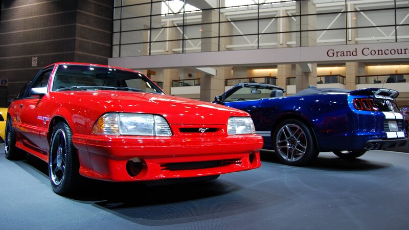 Red and blue Mustang cars on display