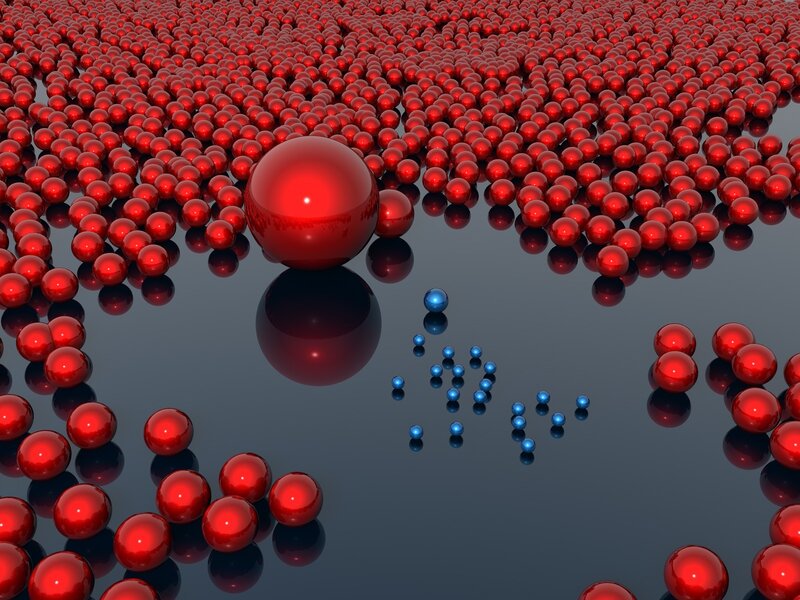 Red and blue spheres on reflective surface