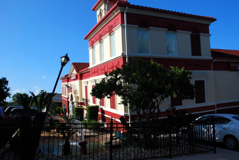 Red and cream building with fountain