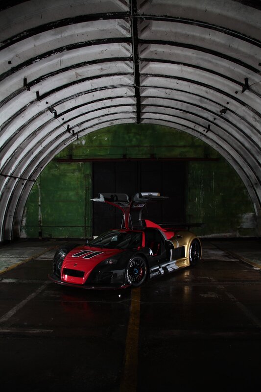 Red and gold race car in garage