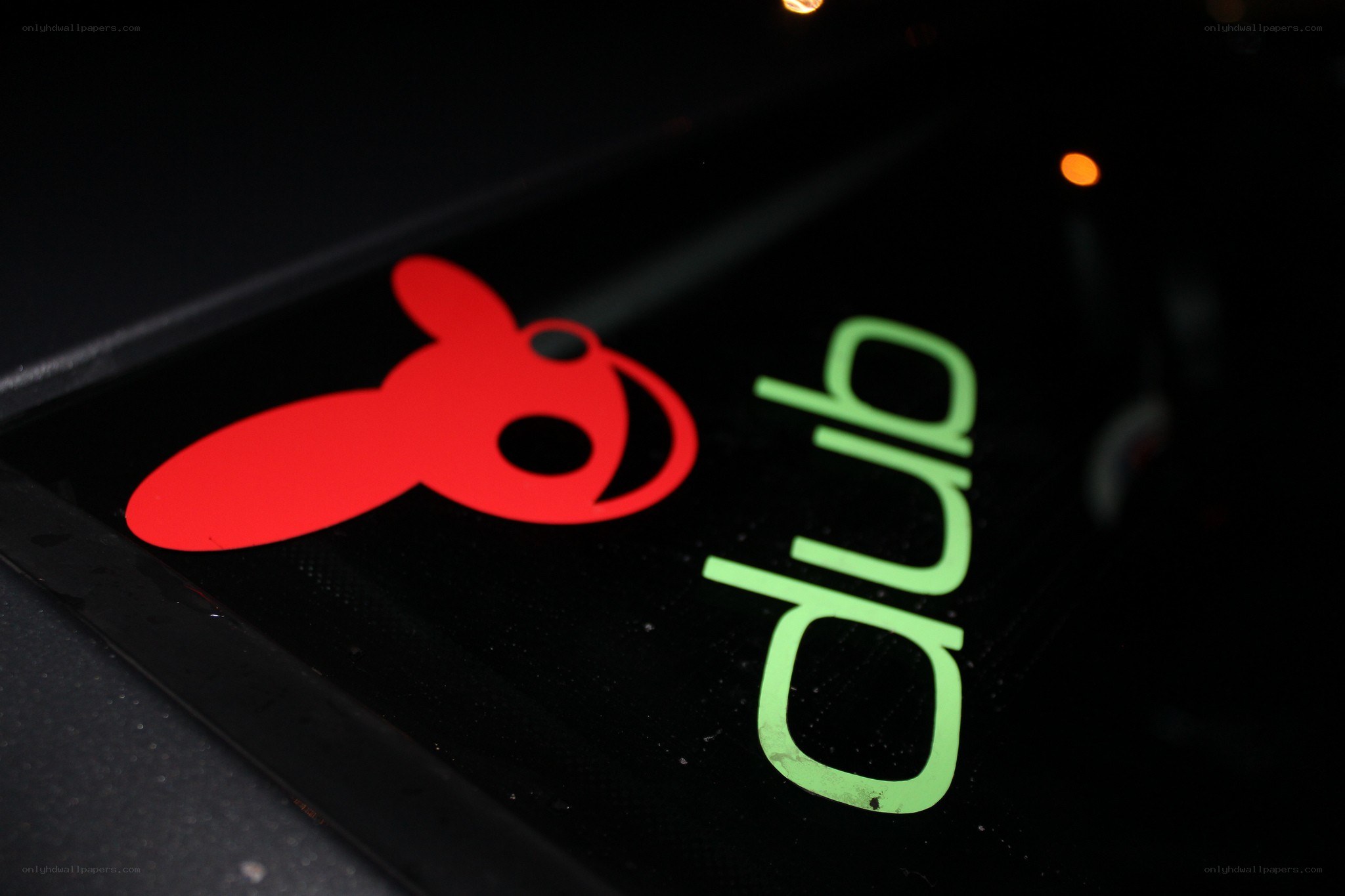 red and green logo on black surface