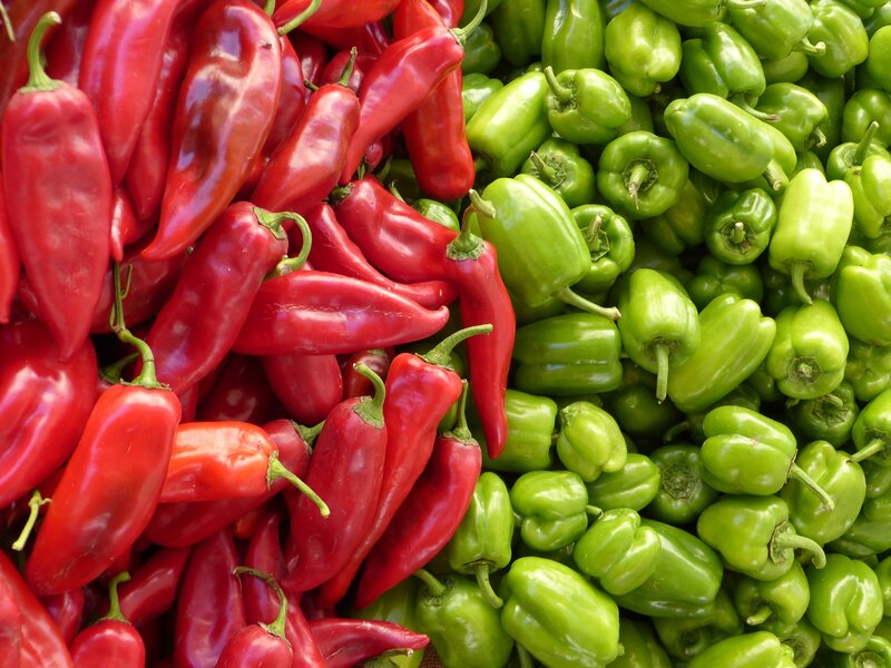 Red and green peppers at market