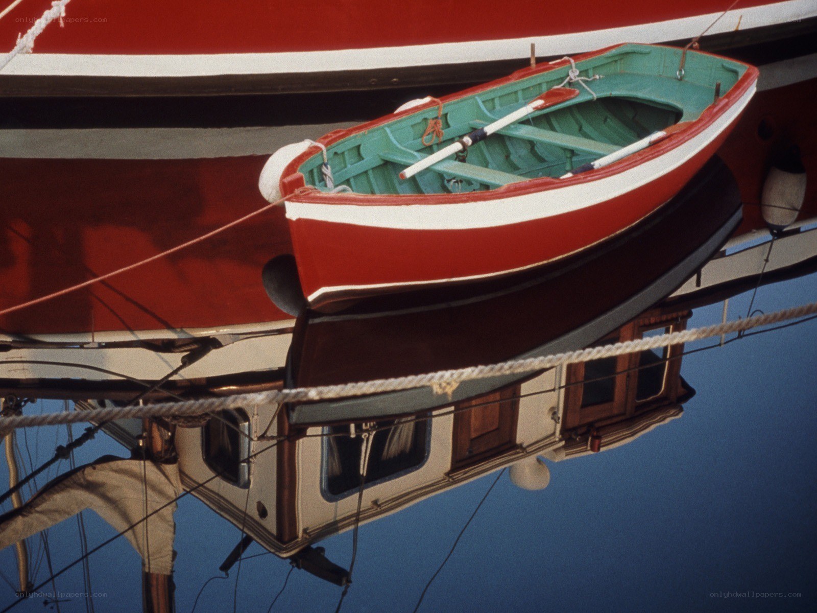 Red and green rowboat on a ship