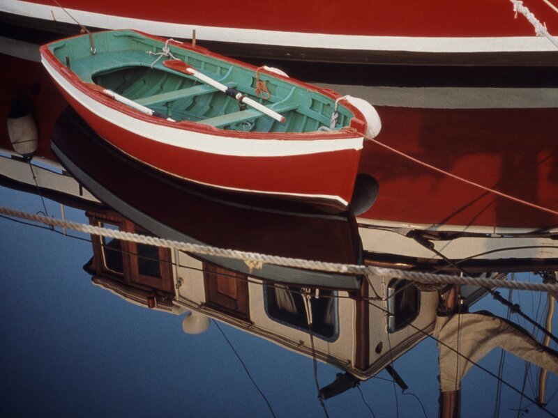 Red and green rowboat reflection