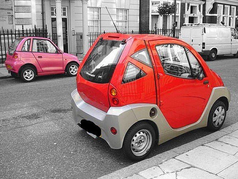 Red and pink microcars on street