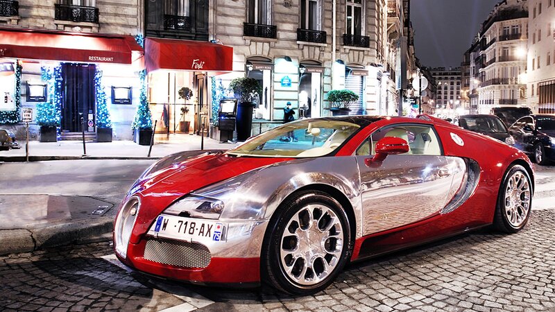 Red and silver Bugatti on city street