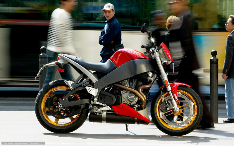 Red and silver motorcycle on city street