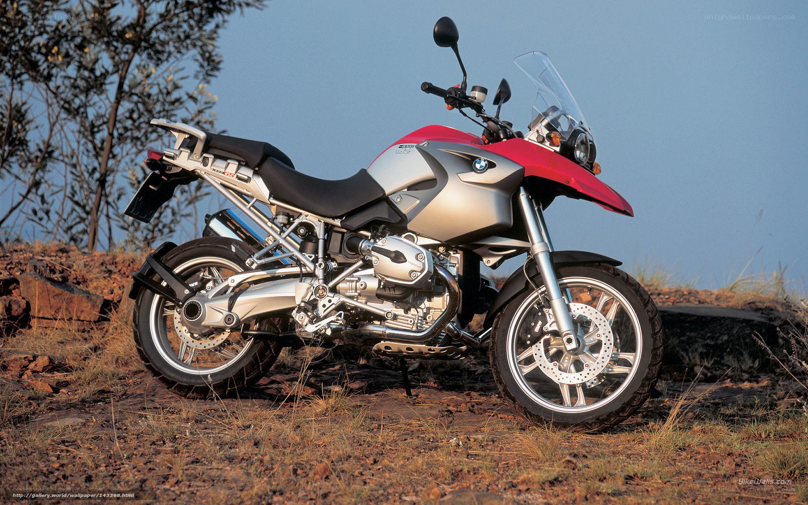 red and silver motorcycle on hillside