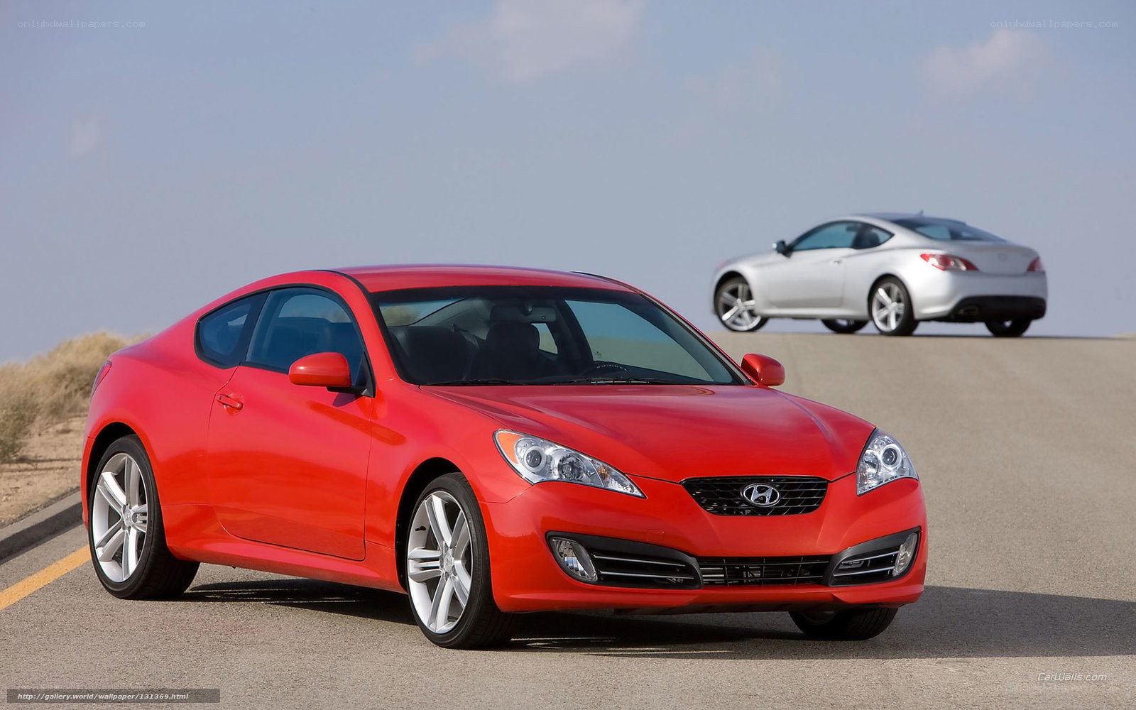 Red and silver sports cars on road