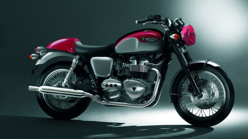red and silver triumph motorcycle