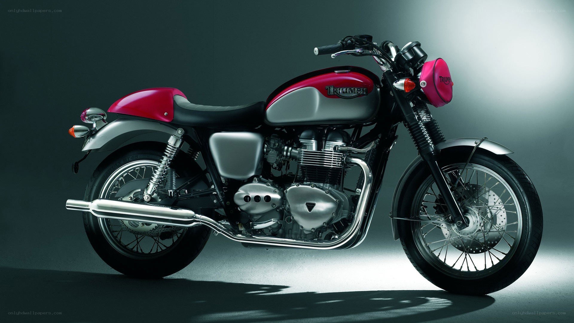 red and silver triumph motorcycle