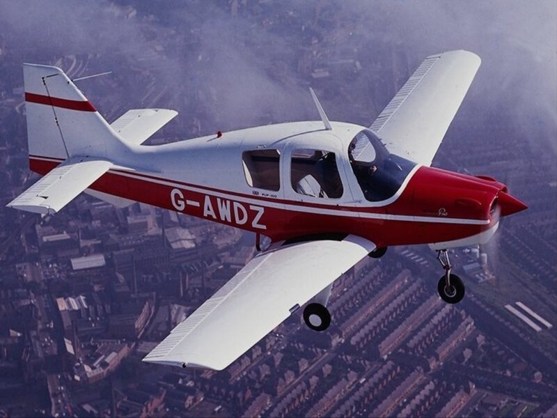 Red and white airplane in flight