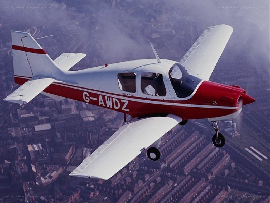 Red and white airplane in flight