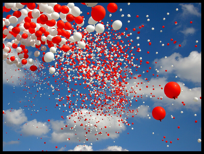 Red and white balloons in the sky