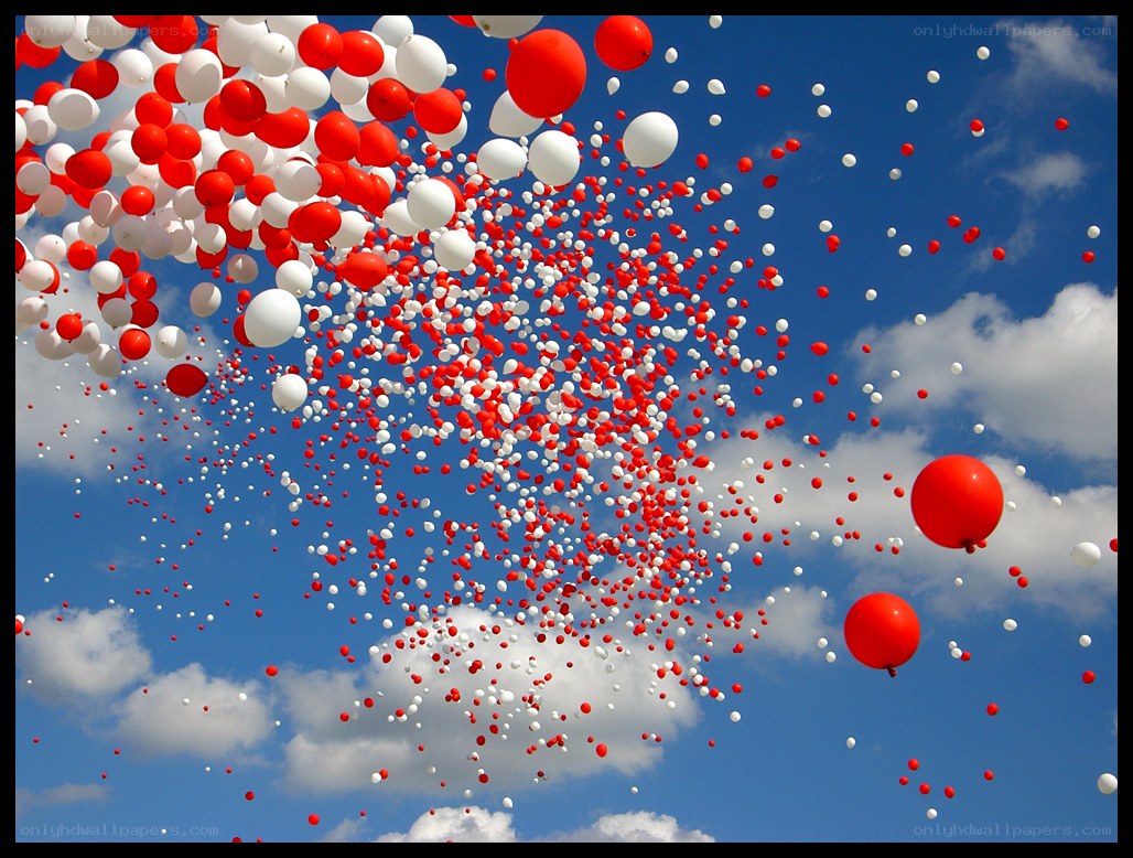 Red and white balloons in the sky