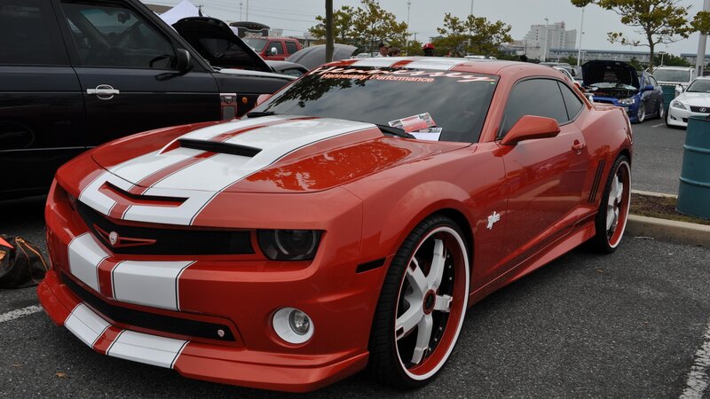 Red and white Camaro at car show
