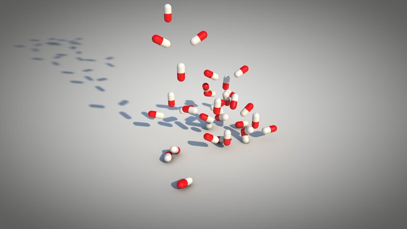 Red and white capsules falling