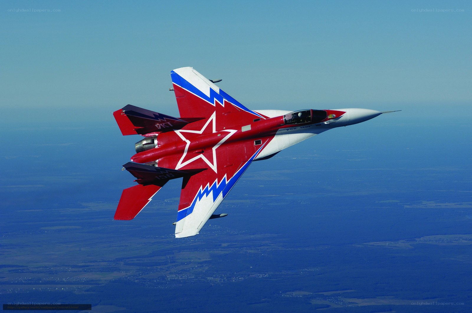 Red and white fighter jet in flight