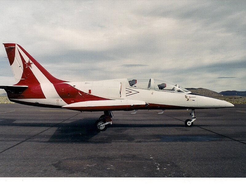 Red and White Jet Aircraft — Overcast